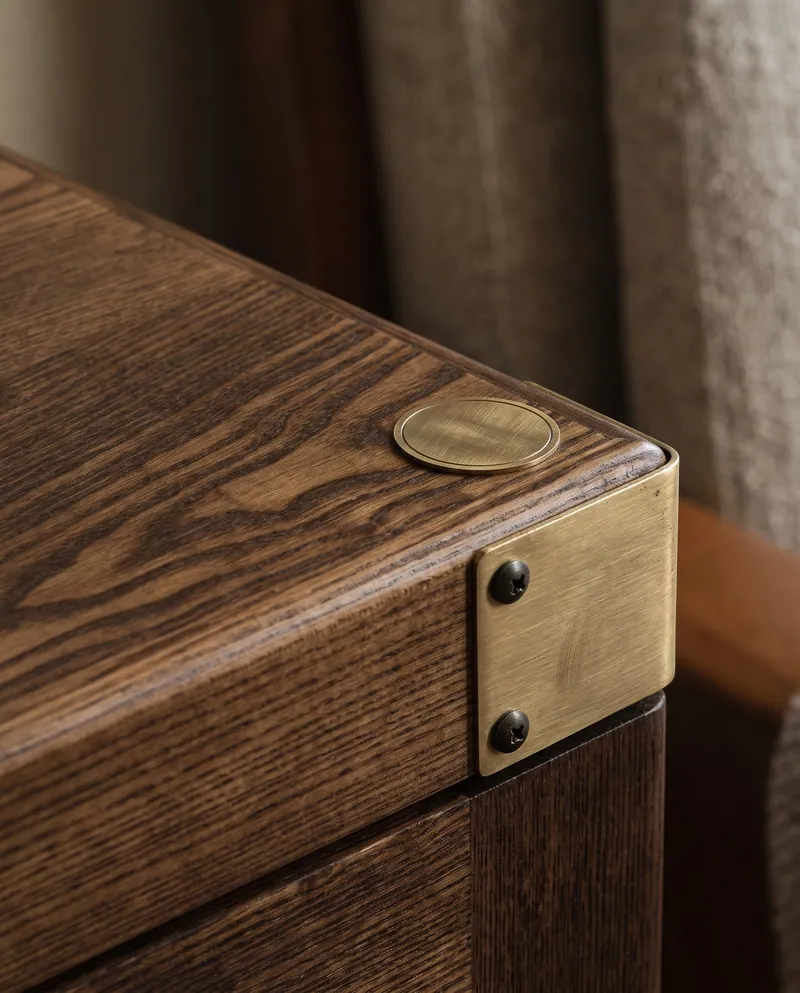 A brass corner on the wire-brushed ash lid